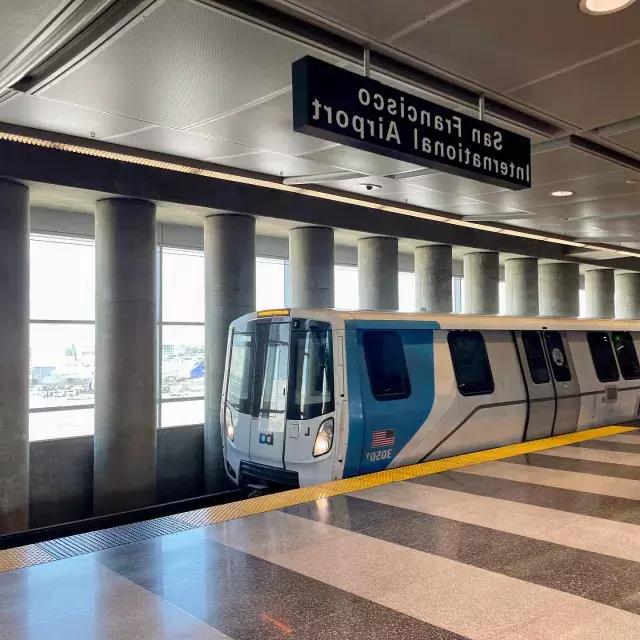 A BART train waits for passengers at the station.